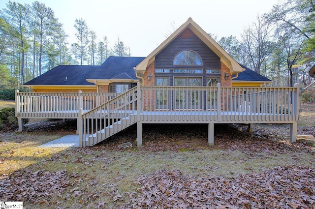 rear view of property with a wooden deck