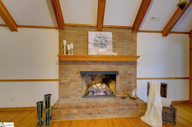 room details with beam ceiling, a fireplace, and hardwood / wood-style floors