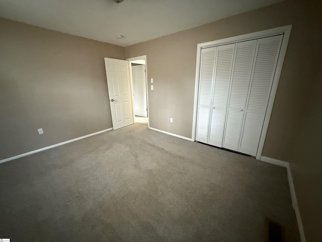 unfurnished bedroom featuring a closet and light carpet