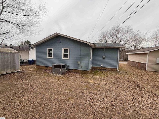 rear view of house featuring central air condition unit