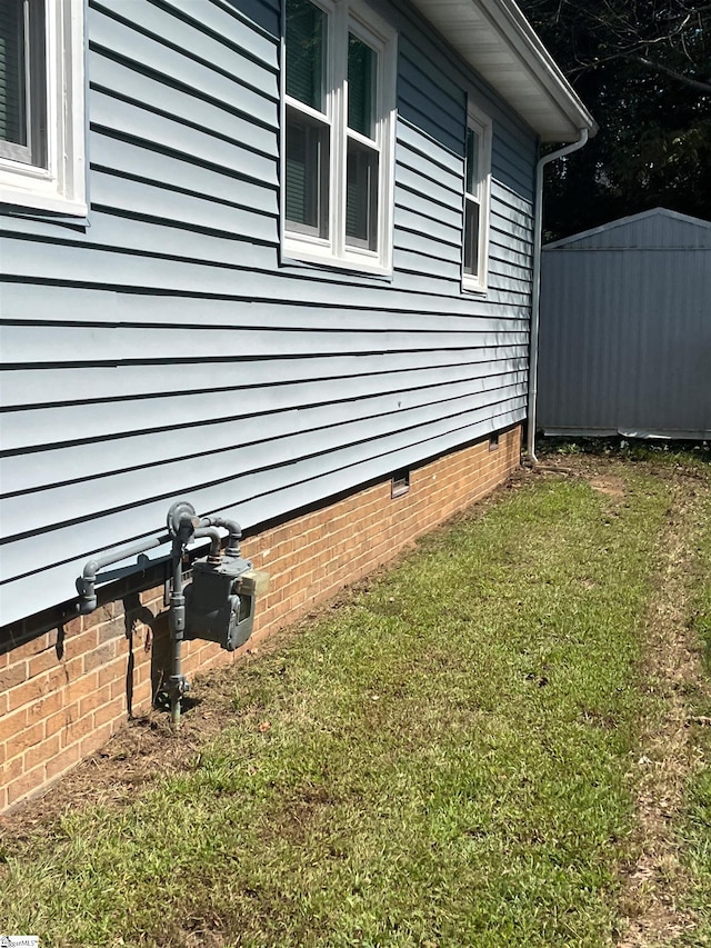 view of side of home with a lawn