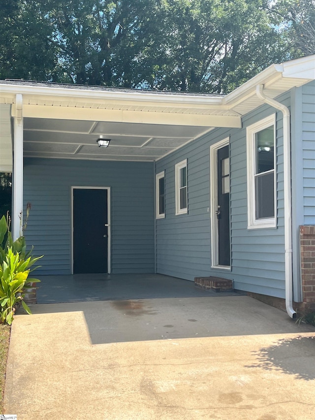 back of property featuring a carport