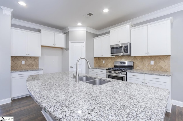 kitchen with white cabinets, appliances with stainless steel finishes, and sink