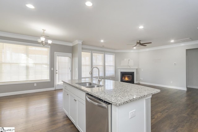 kitchen featuring a center island with sink, plenty of natural light, dishwasher, white cabinets, and sink