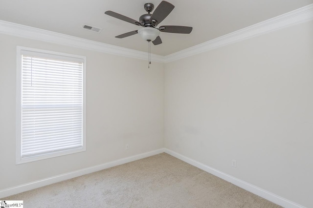 carpeted empty room featuring ceiling fan and crown molding