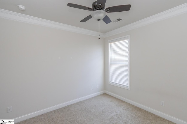 spare room with ceiling fan, plenty of natural light, light carpet, and ornamental molding