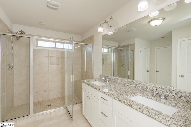 bathroom with vanity, tile patterned flooring, and walk in shower