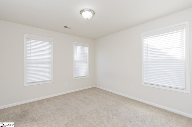 spare room with light carpet