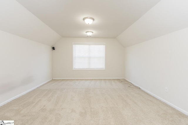 bonus room featuring light colored carpet and vaulted ceiling