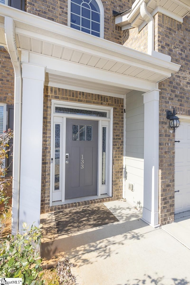 view of exterior entry featuring a porch