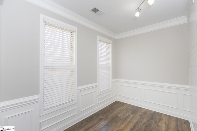 spare room with dark wood-type flooring and crown molding