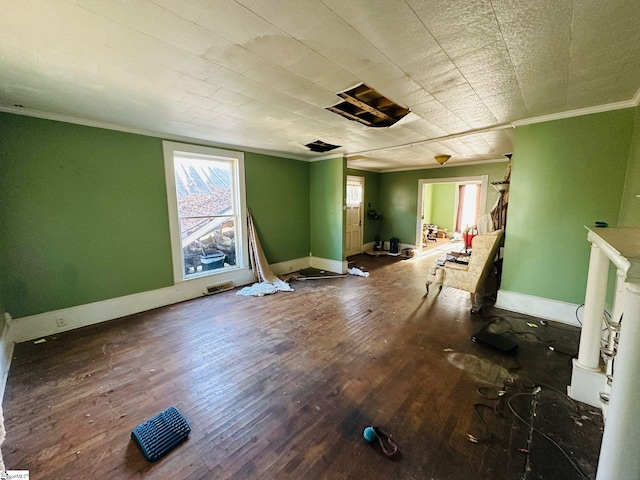 spare room featuring ornamental molding and hardwood / wood-style floors