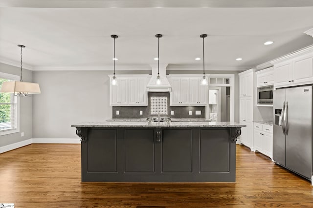 kitchen with a large island, white cabinetry, and stainless steel appliances