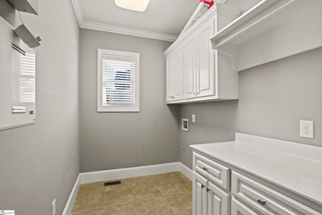 washroom with washer hookup, crown molding, and cabinets