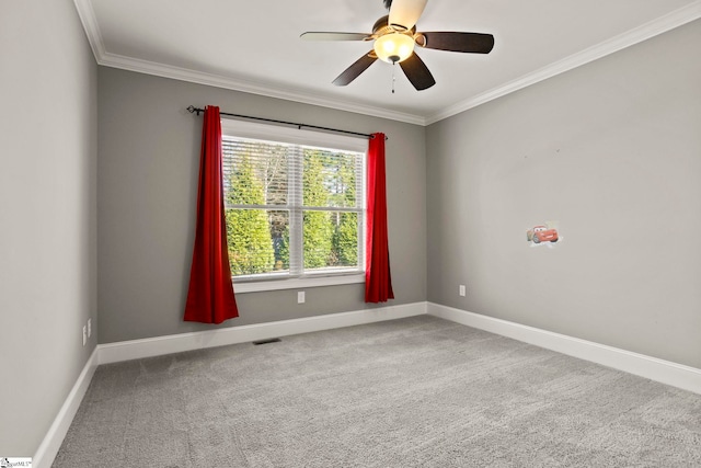 carpeted empty room featuring ceiling fan and ornamental molding