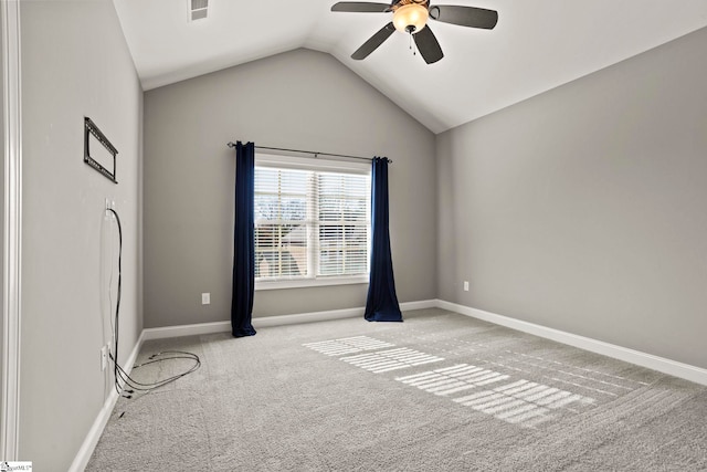 carpeted empty room with vaulted ceiling and ceiling fan