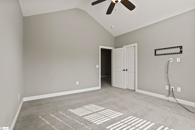 unfurnished bedroom featuring ceiling fan, light colored carpet, and high vaulted ceiling