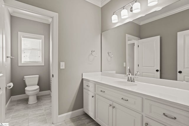 bathroom featuring toilet, vanity, and ornamental molding