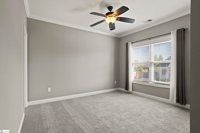 carpeted empty room featuring ceiling fan and crown molding