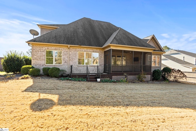 view of front facade featuring a front yard and a sunroom