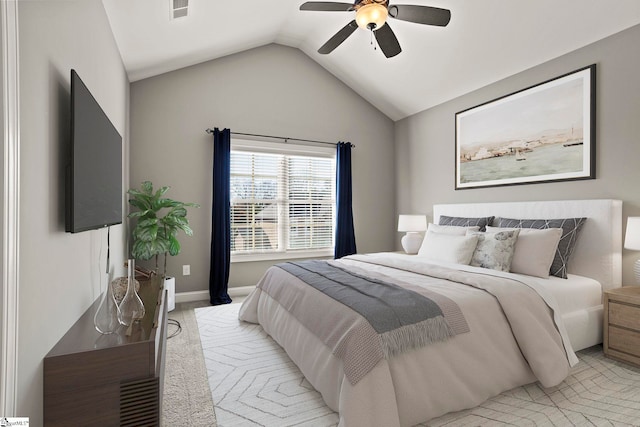 carpeted bedroom with ceiling fan and vaulted ceiling