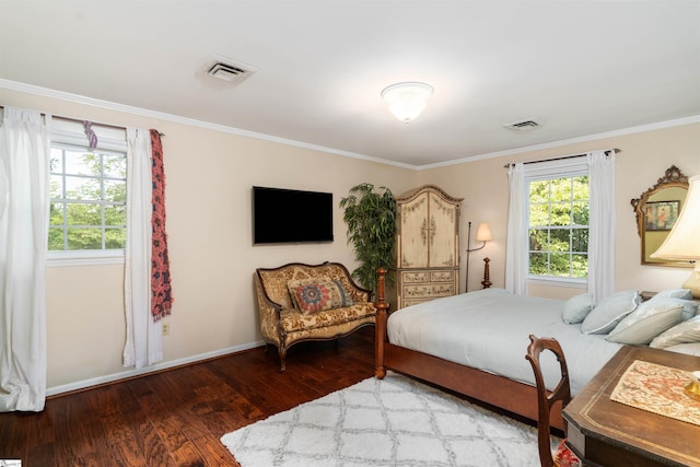 bedroom with crown molding and hardwood / wood-style flooring