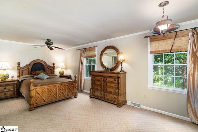 bedroom with ceiling fan, light colored carpet, and ornamental molding