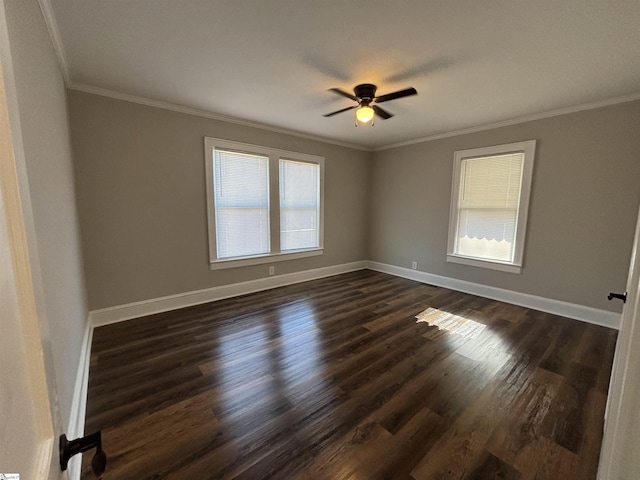 spare room featuring plenty of natural light, dark hardwood / wood-style floors, and crown molding