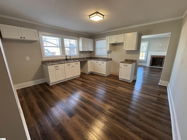 kitchen featuring dark wood-type flooring, white cabinets, and sink