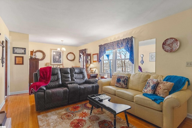 living room featuring an inviting chandelier and hardwood / wood-style flooring