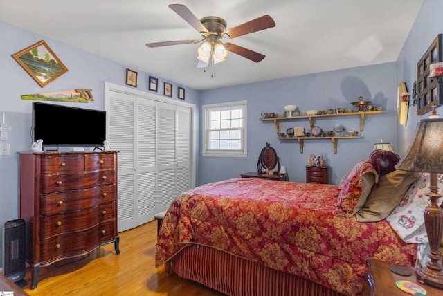 bedroom with ceiling fan, a closet, and light hardwood / wood-style flooring