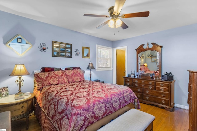 bedroom with ceiling fan and light hardwood / wood-style flooring