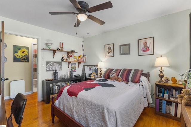 bedroom with ceiling fan and hardwood / wood-style flooring