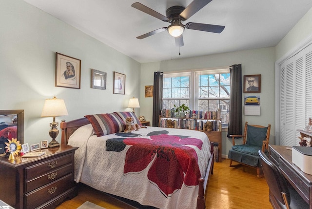 bedroom with a closet, light hardwood / wood-style floors, and ceiling fan