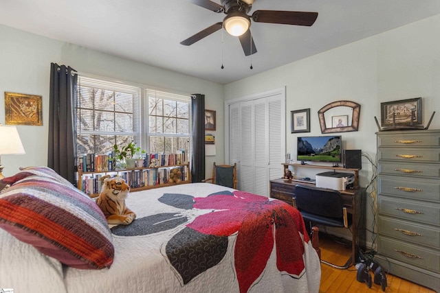 bedroom featuring ceiling fan, a closet, and light hardwood / wood-style flooring