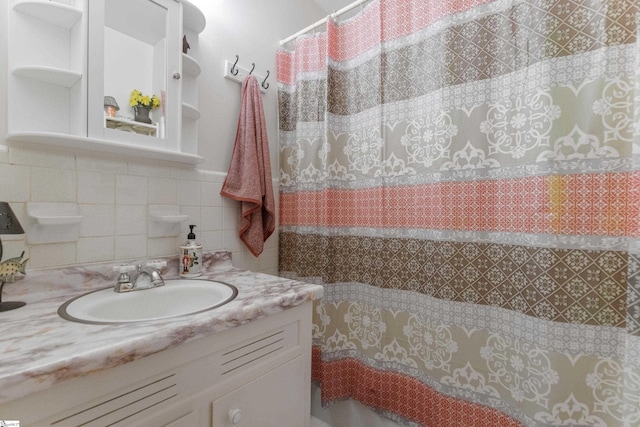 bathroom with tile walls and vanity