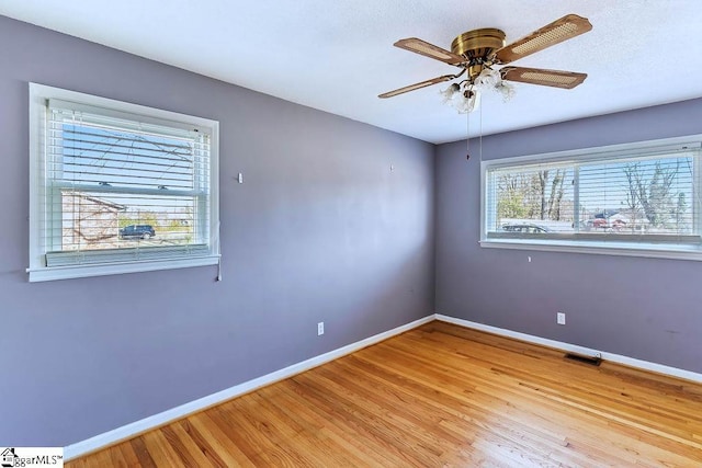 empty room featuring ceiling fan and light hardwood / wood-style flooring