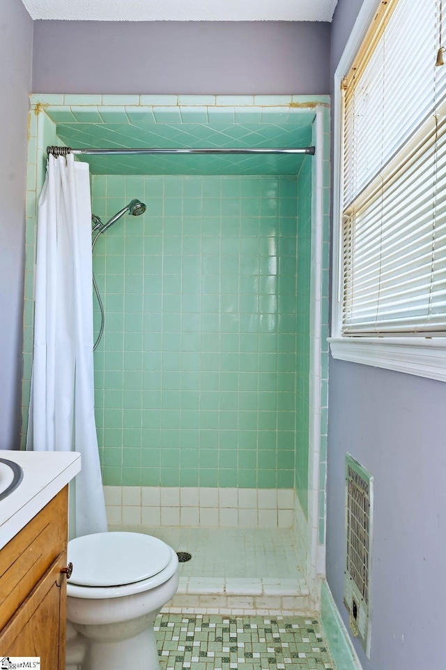 bathroom featuring toilet, heating unit, vanity, and a shower with shower curtain