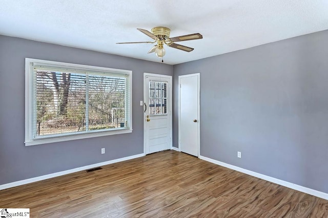 spare room featuring ceiling fan and hardwood / wood-style flooring