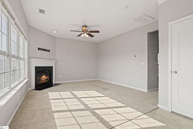 unfurnished living room with ceiling fan and light colored carpet