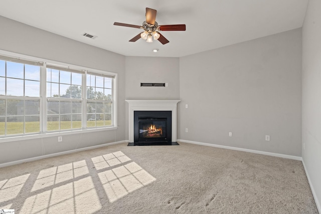 unfurnished living room featuring ceiling fan and light colored carpet