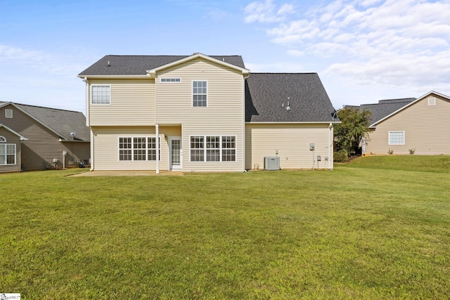 rear view of house featuring central AC, a lawn, and a patio