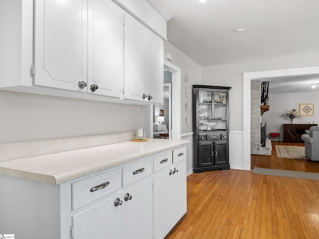 kitchen featuring white cabinets and light hardwood / wood-style flooring