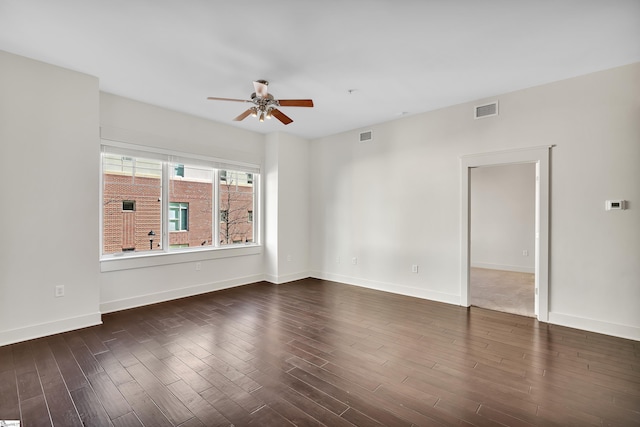 spare room with ceiling fan and dark hardwood / wood-style flooring