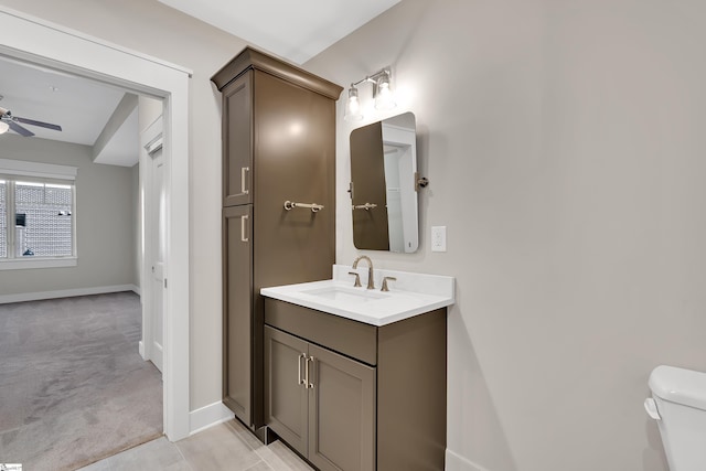 bathroom featuring ceiling fan, vanity, toilet, and tile patterned floors