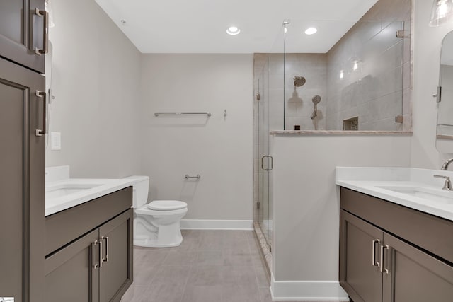 bathroom with vanity, an enclosed shower, and toilet