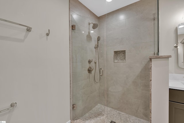 bathroom featuring vanity and a shower with shower door