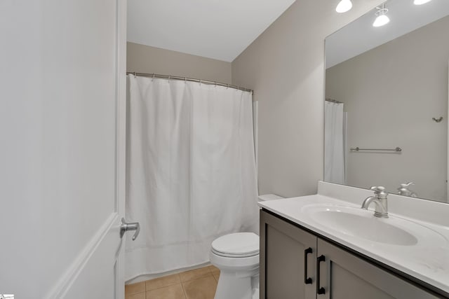 bathroom featuring vanity, tile patterned floors, and toilet