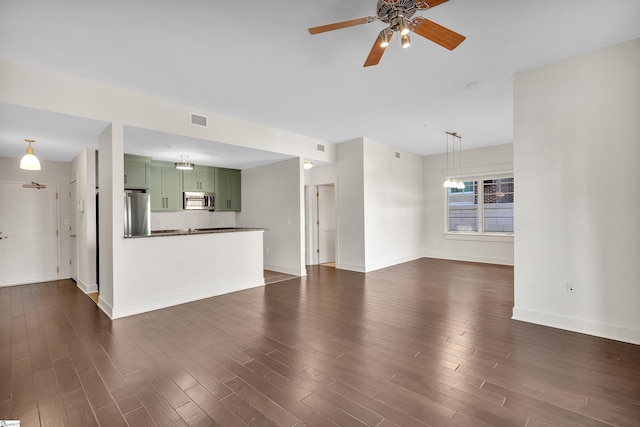 unfurnished living room with dark hardwood / wood-style floors and ceiling fan