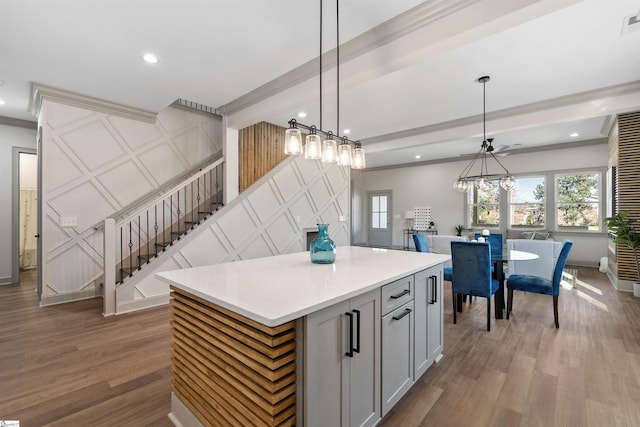 kitchen with wood-type flooring, pendant lighting, and a center island